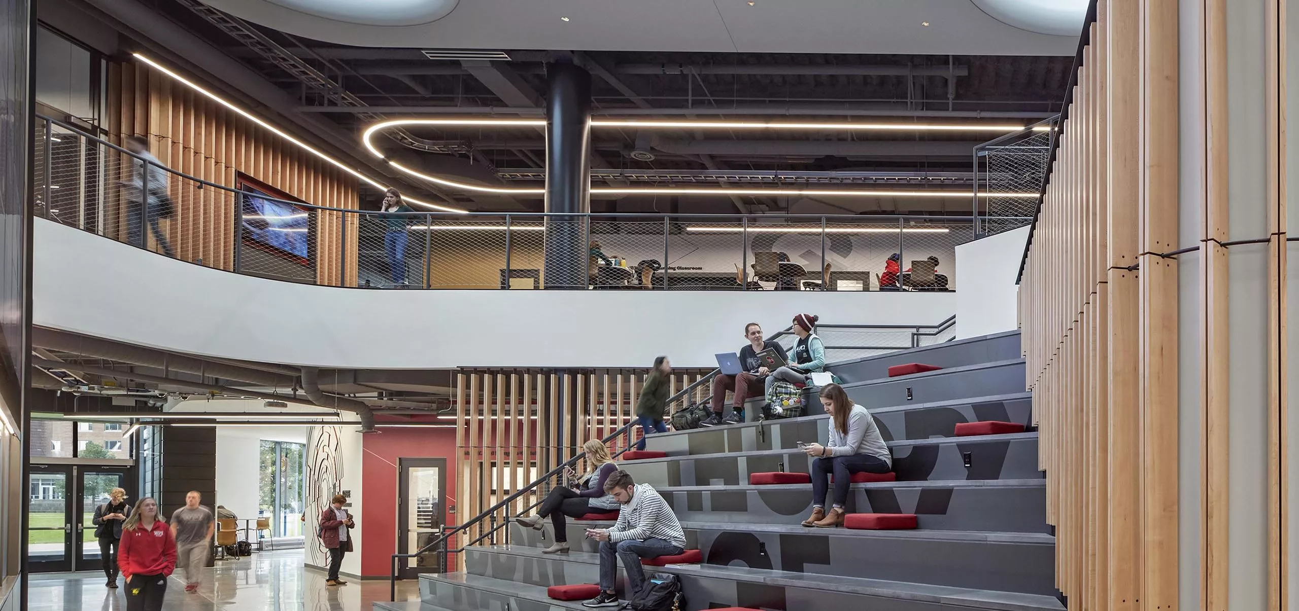 People sitting on the large stairs in Innovation Studio & Messenger Residence Hall