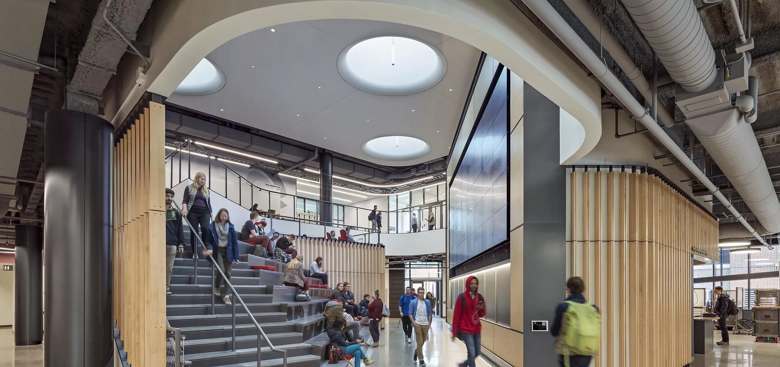 Group of people walking down a staircase in Innovation Studio & Messenger Residence Hall