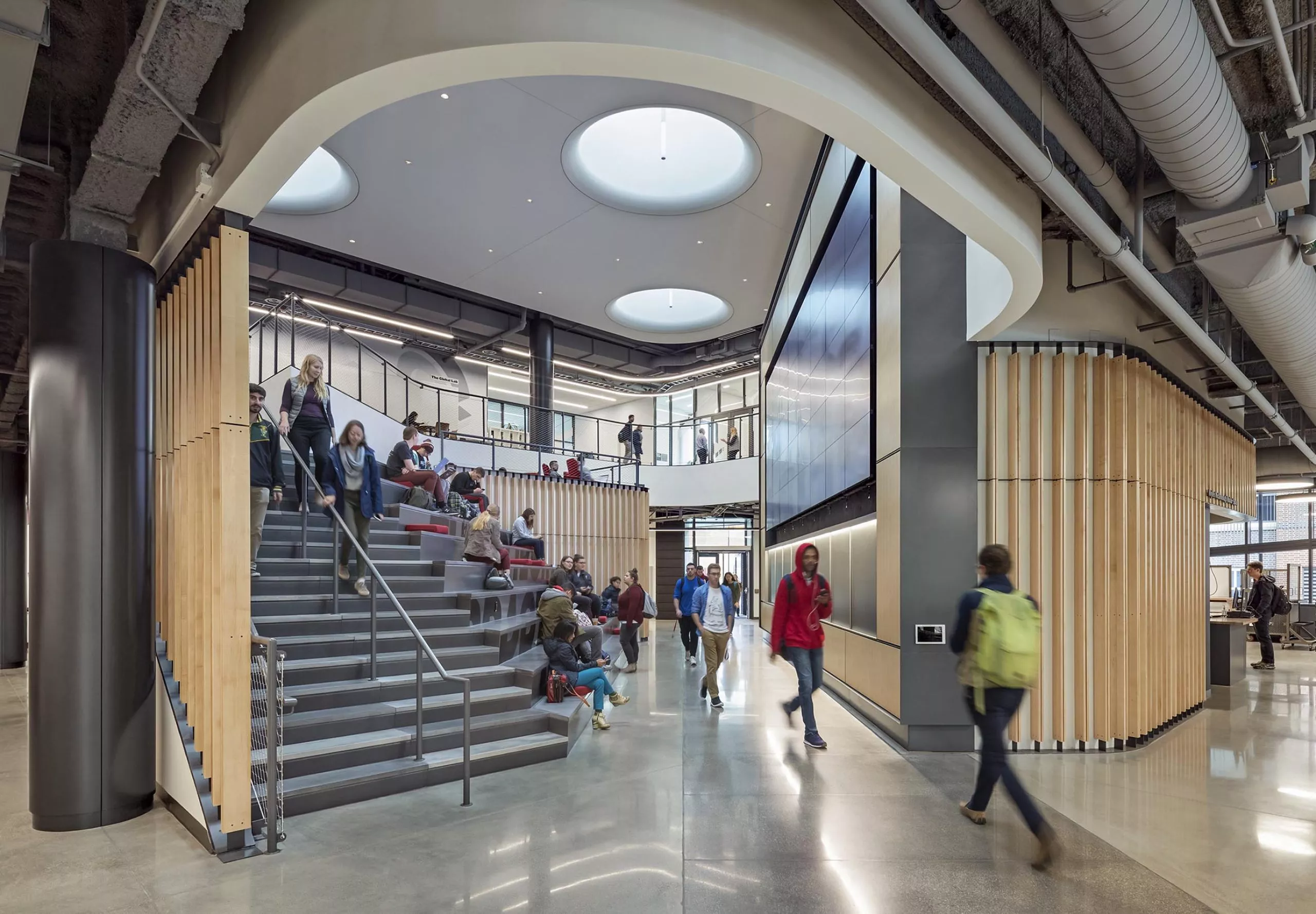 Group of people walking down a staircase in Innovation Studio & Messenger Residence Hall