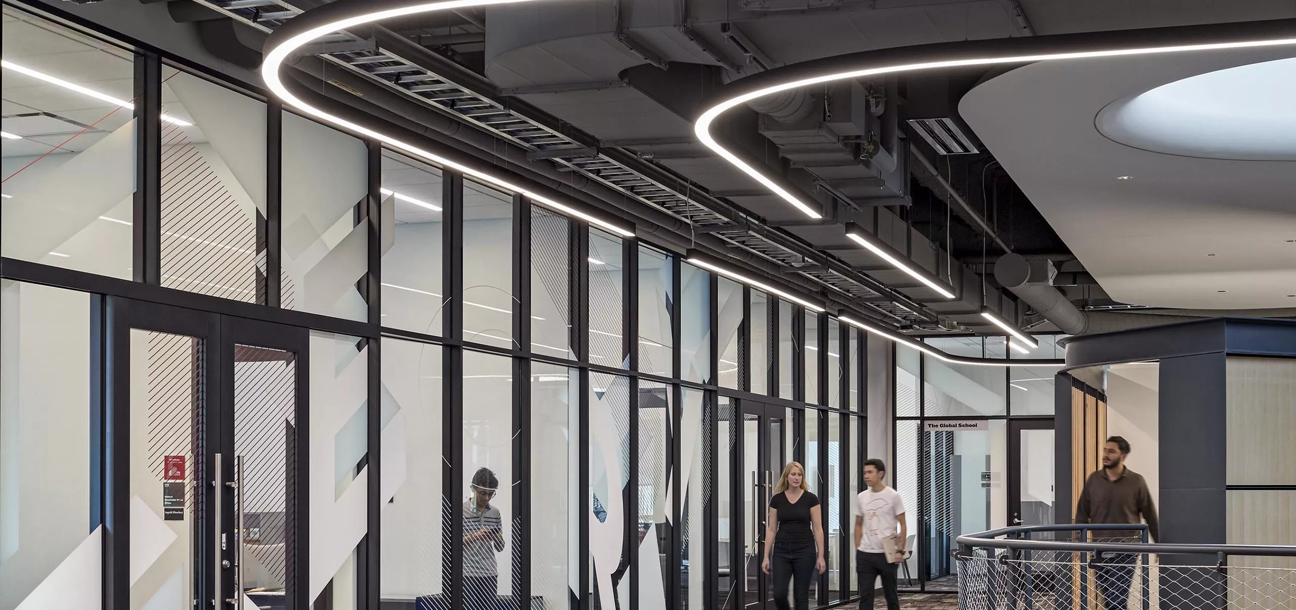 People walking in a hallway in Ithe nnovation Studio & Messenger Residence Hall