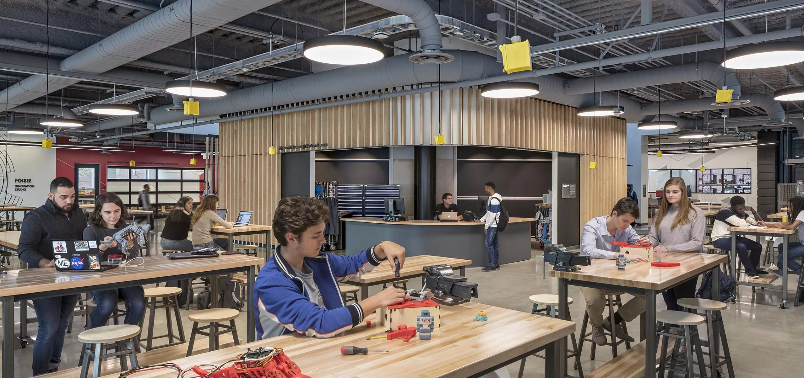 A group of people working on robotics in Innovation Studio & Messenger Residence Hall