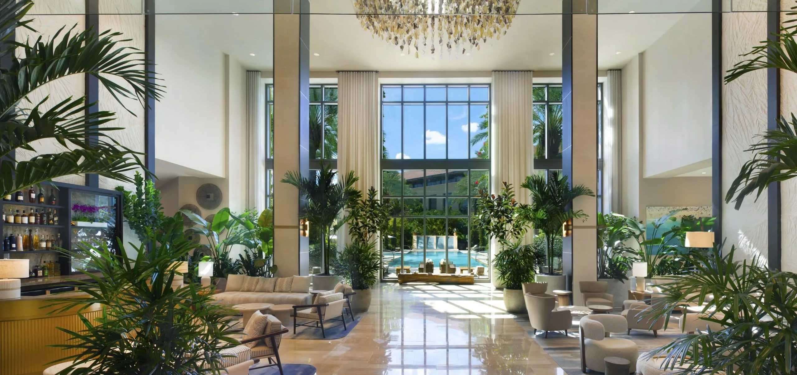 Indoor lobby with seating and plants at Hilton West Palm Beach