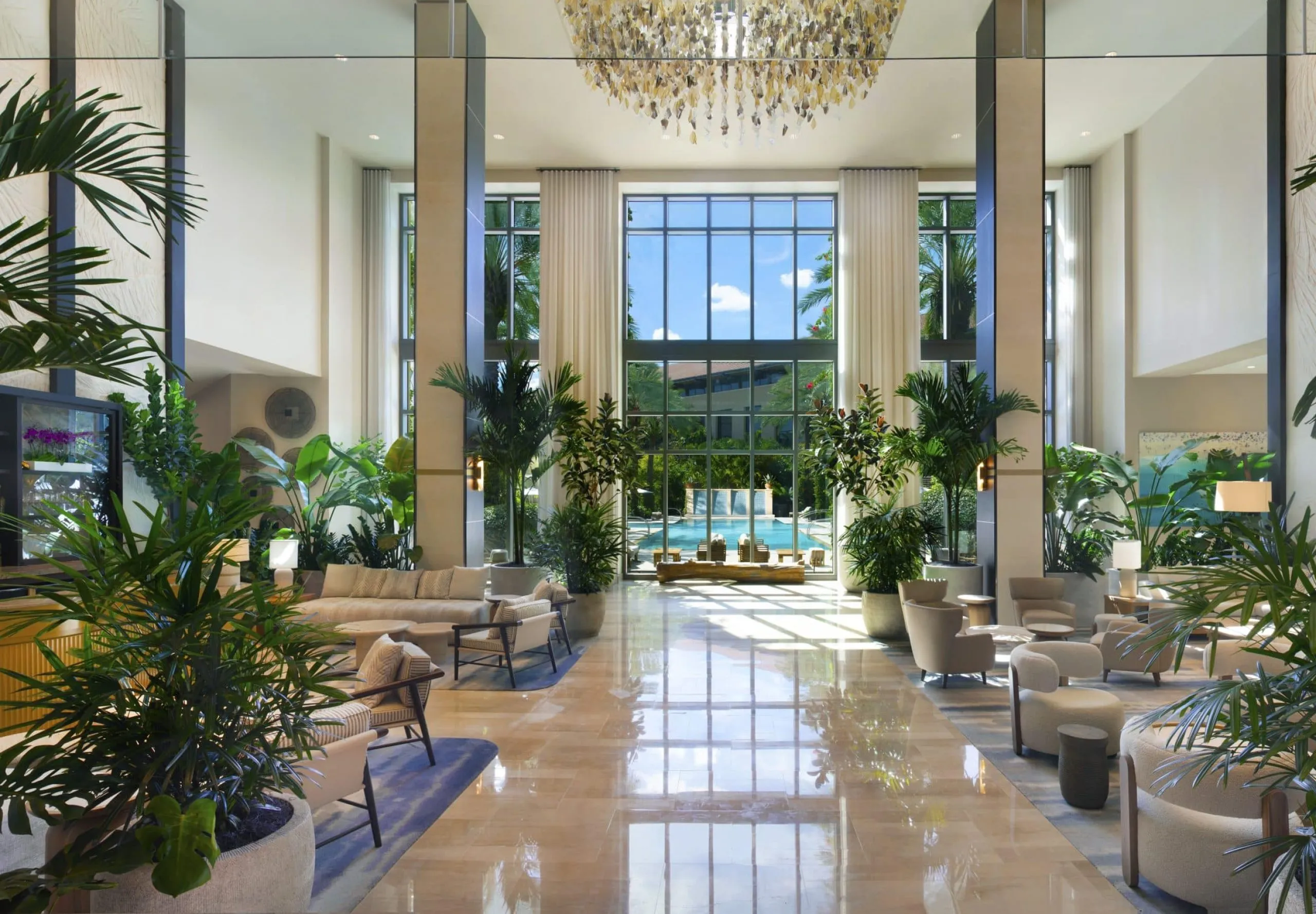 Indoor lobby with seating and plants at Hilton West Palm Beach