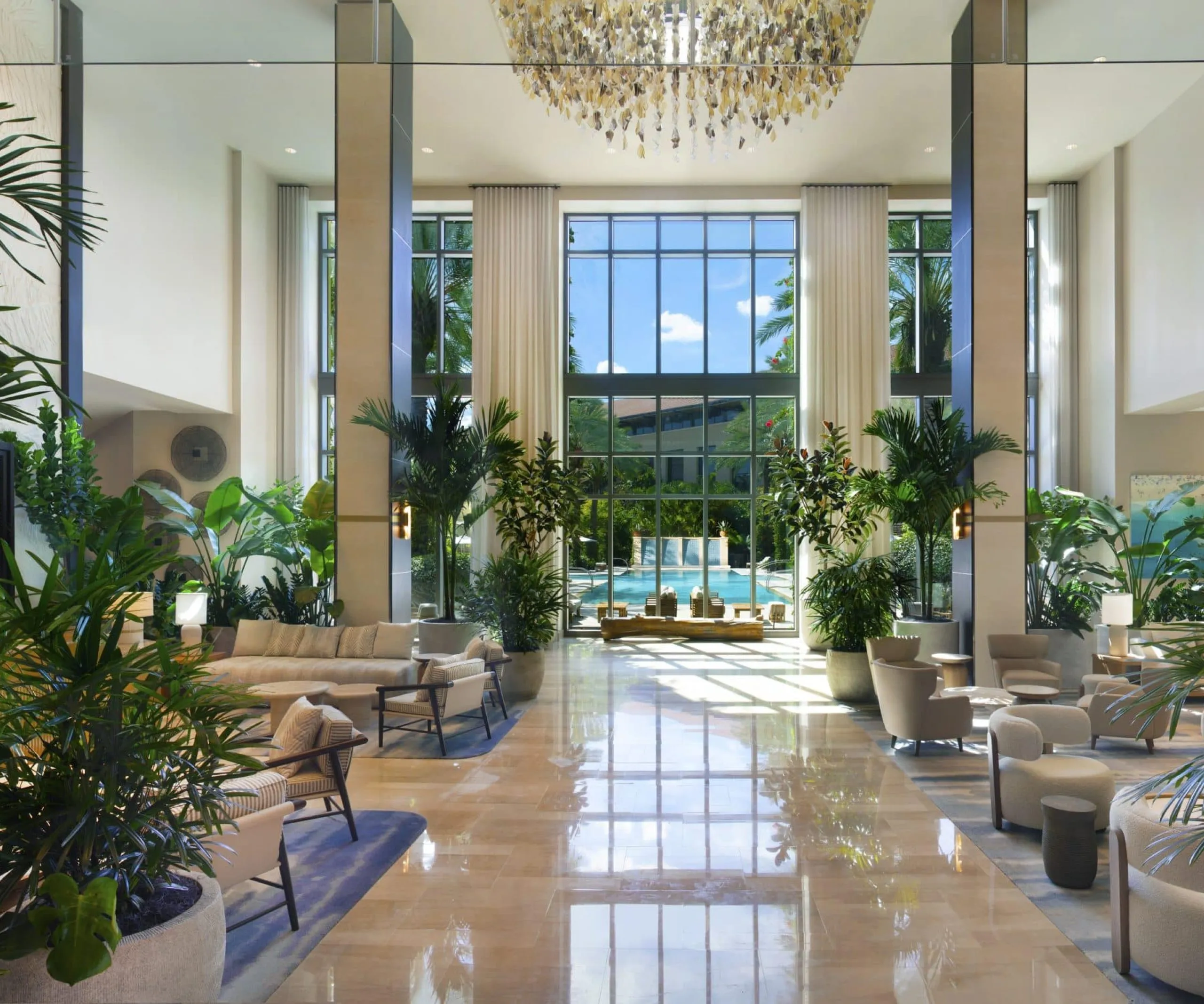 Indoor lobby with seating and plants at Hilton West Palm Beach