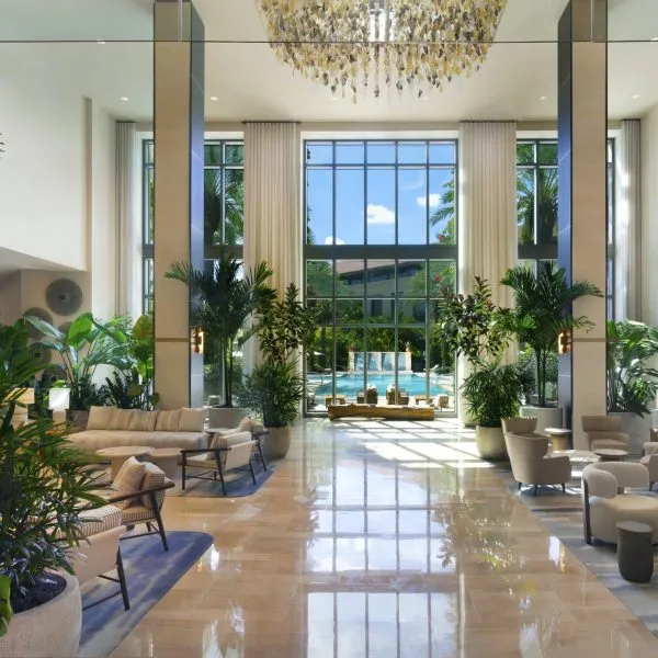 Indoor lobby with seating and plants at Hilton West Palm Beach